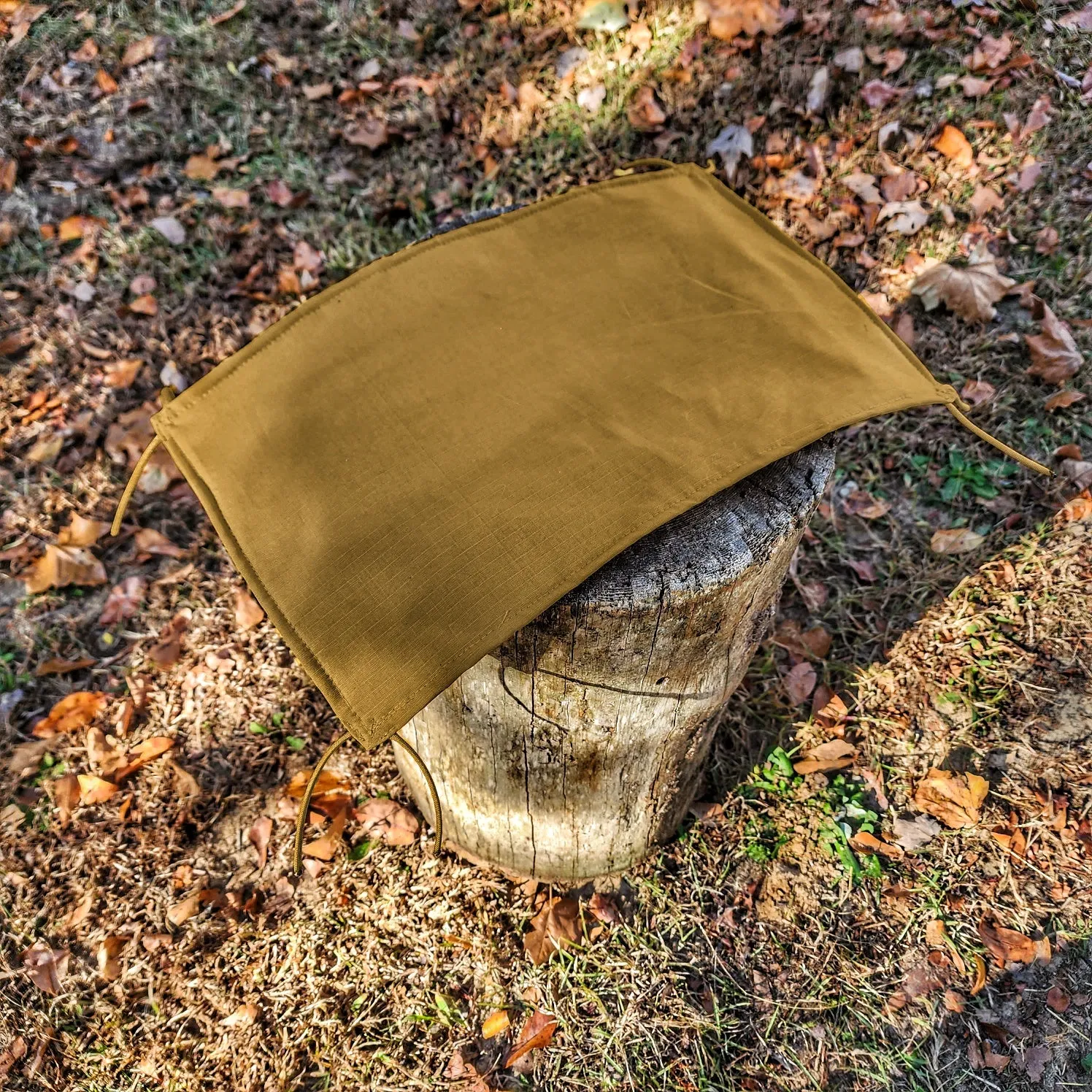 Woobie Hank: Insulated with USGI poncho-liner, serves as a large rag, knee pad, and adventure companion tool.